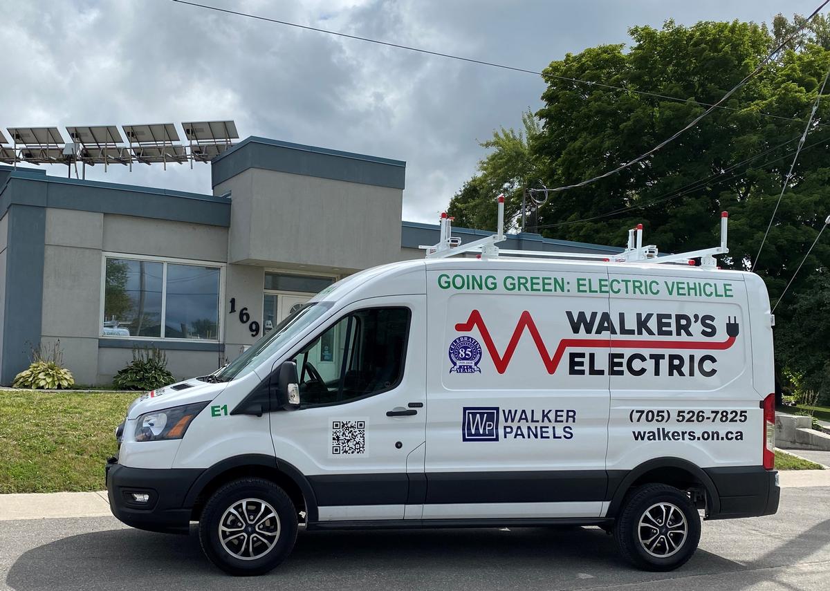 Walker's Electric all-electric service van parked outside the Bay Street shop with rooftop solar array
